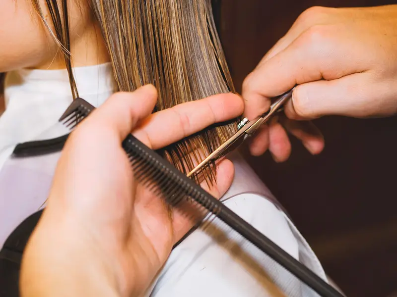 Beauty professional working with a client in a salon