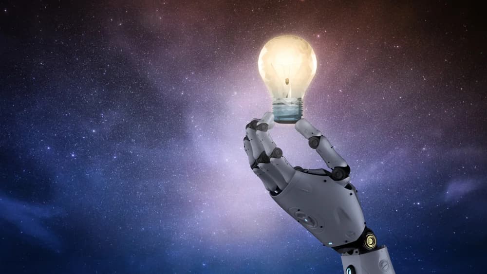 Robot hand holding an illuminated light bulb