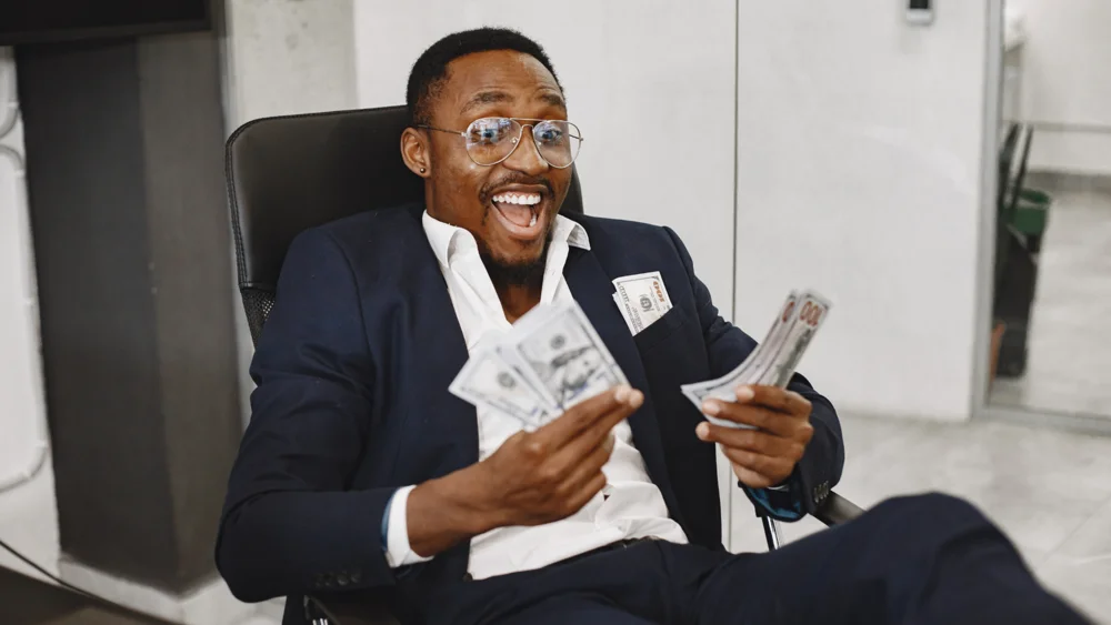 Founder holding cash while planning a funding round