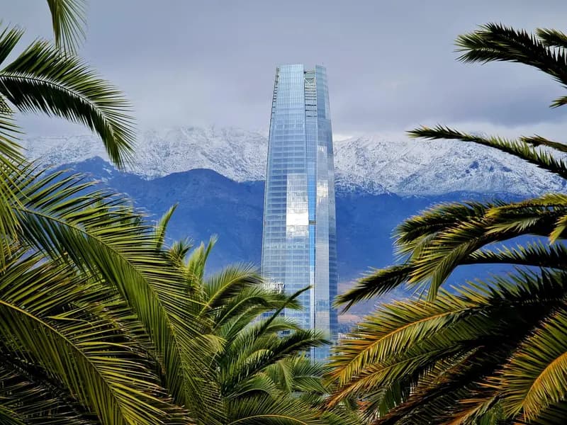 Santiago skyline and the Andes viewed through palm trees