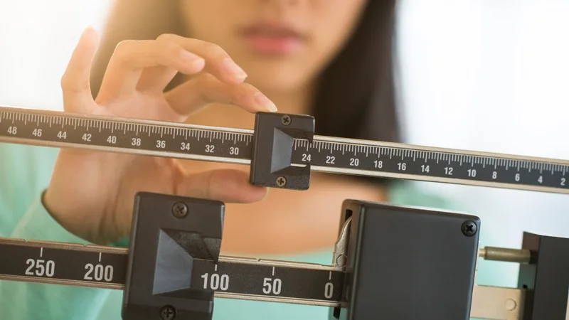 A person balancing a scale, illustrating valuation tradeoffs